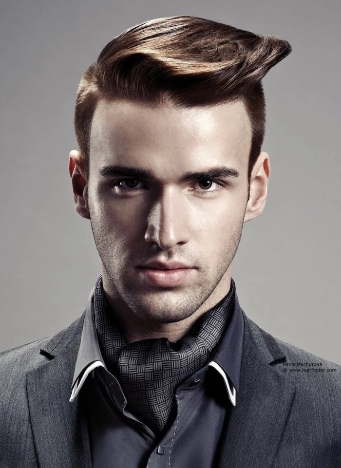 cool haircuts for men, grey jacket, navy satin shirt, brown hair, grey background