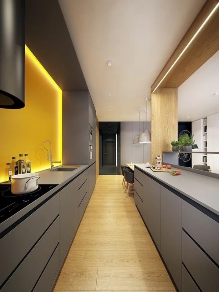 narrow kitchen island, grey cabinets and drawers, yellow backsplash, led lights, wooden floor