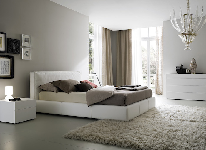white leather bed, grey tiled floor, white carpet, master bedroom decor, framed art, tall windows