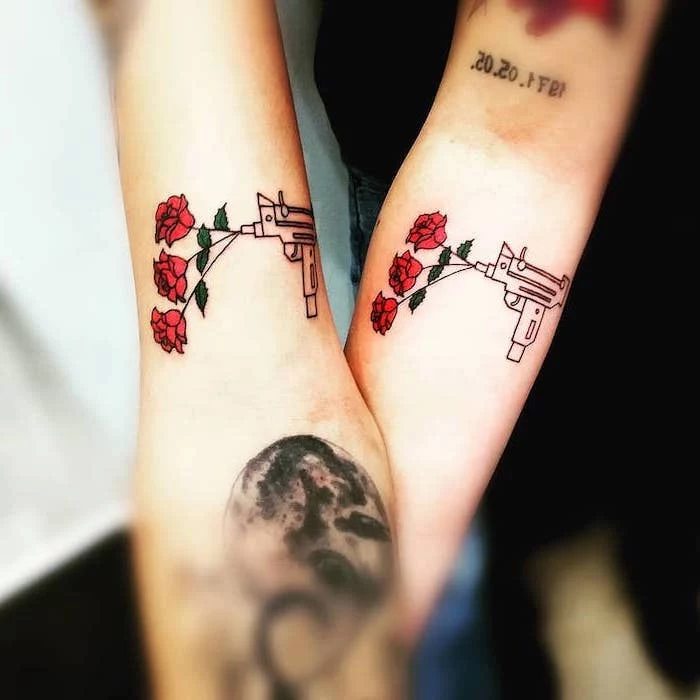 guns and roses, forearm tattoos, husband wife tattoos, blurred background