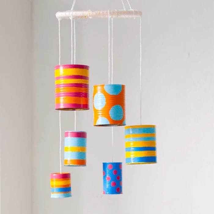 preschool learning, tin cans, painted in different patterns, hanging on macrame