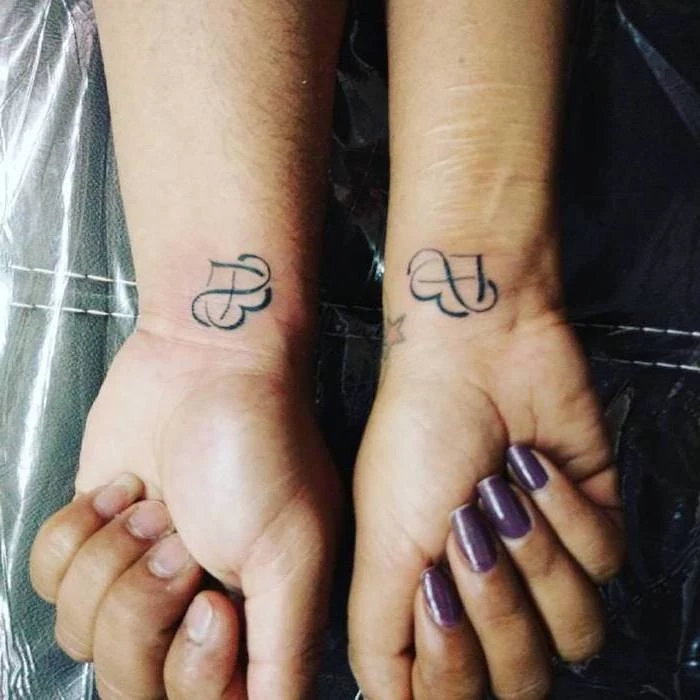 purple nails, heart and infinity symbol intertwined, wrist tattoos, husband wife tattoos