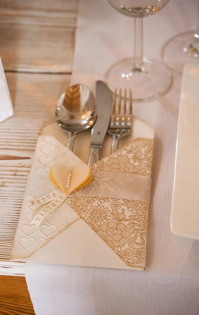 luxury wedding napkins, silverware inside, fancy napkin folding, white table runner, wooden background