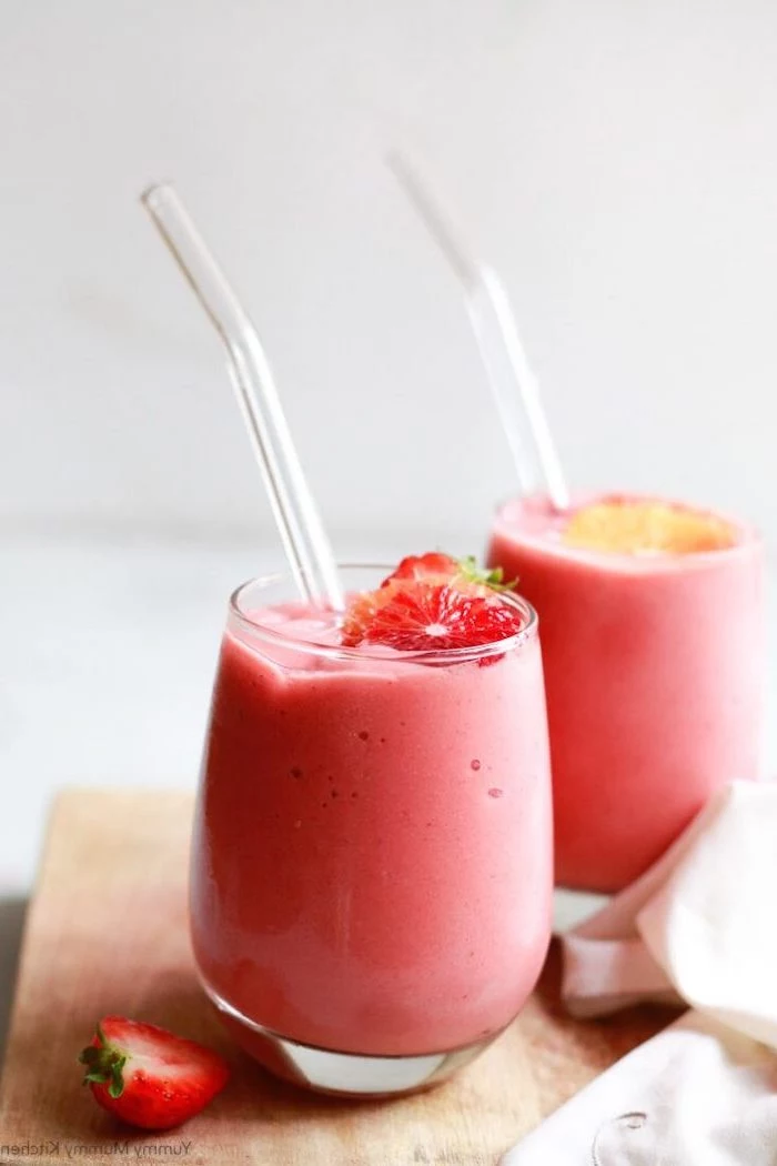 wooden board, pink smoothie, breakfast smoothie recipes, strawberry slices on top