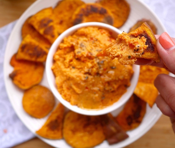 hummus in a white bowl, baked sweet potato chips on the side, easy vegetarian appetizers