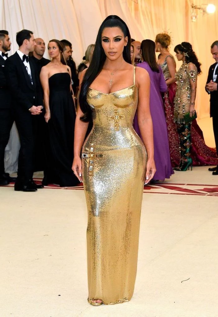 kim kardashian, met gala theme, long gold dress, crystal crosses, long black ponytail