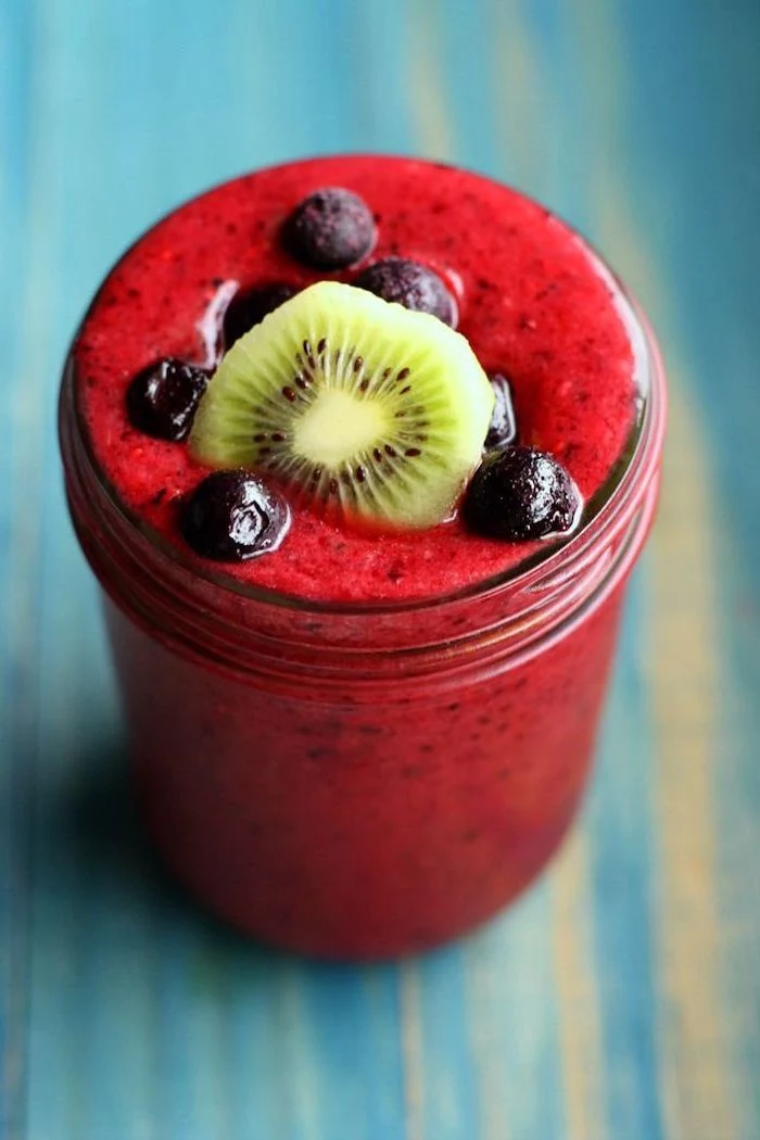 red smoothie, protein smoothie recipes, blackberries and kiwi slice on top