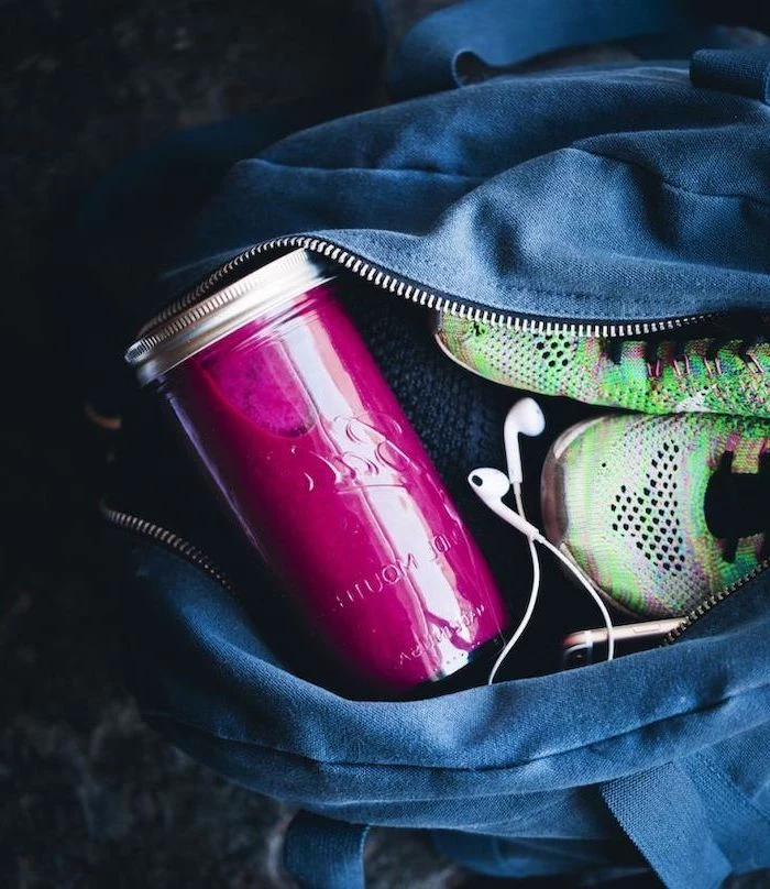 pink smoothie, in a glass bottle, sneakers and headphones in bag, protein smoothie recipes
