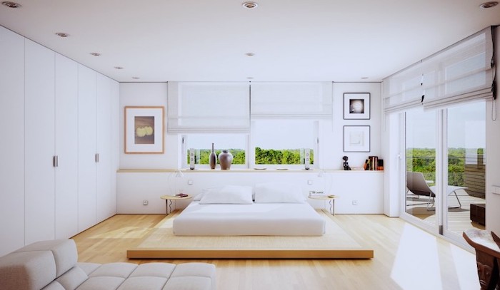 wooden bed frame, white walls, small master bedroom ideas, white sofa, tall windows