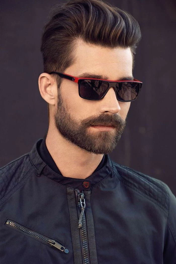 hair styles for men, man wearing sunglasses, black jacket, brown hair and beard
