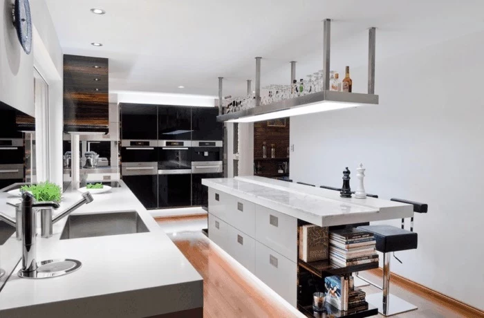 kitchen island countertop, black and white cabinets, white countertops, hanging shelf