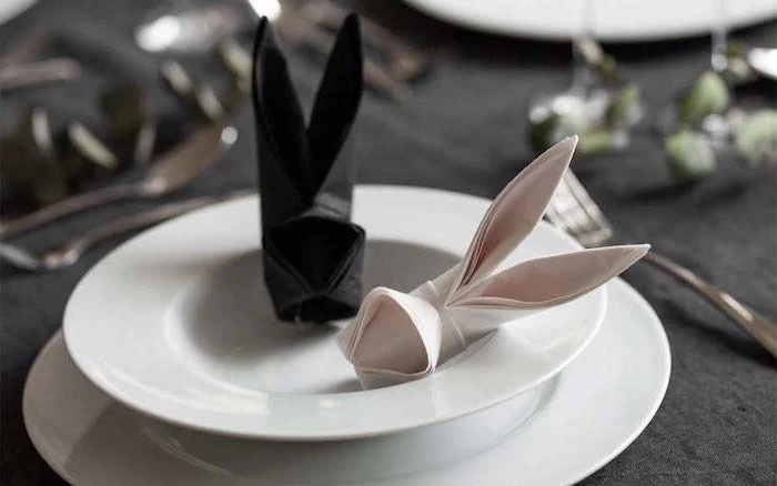 bunny shaped, pink and black napkin, napkin folding with rings, white plates, black table cloth