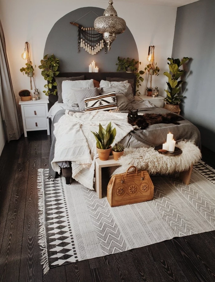 wooden floor, macrame hanging, white and grey walls, potted plants, white night stand