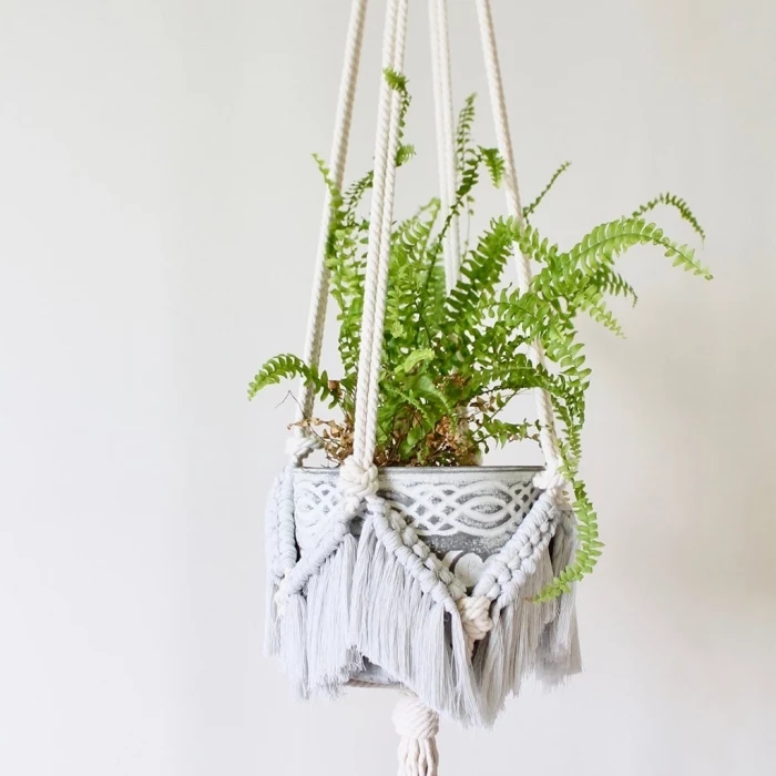potted plant, macrame wall art, metal pot, white wall, plant hanger