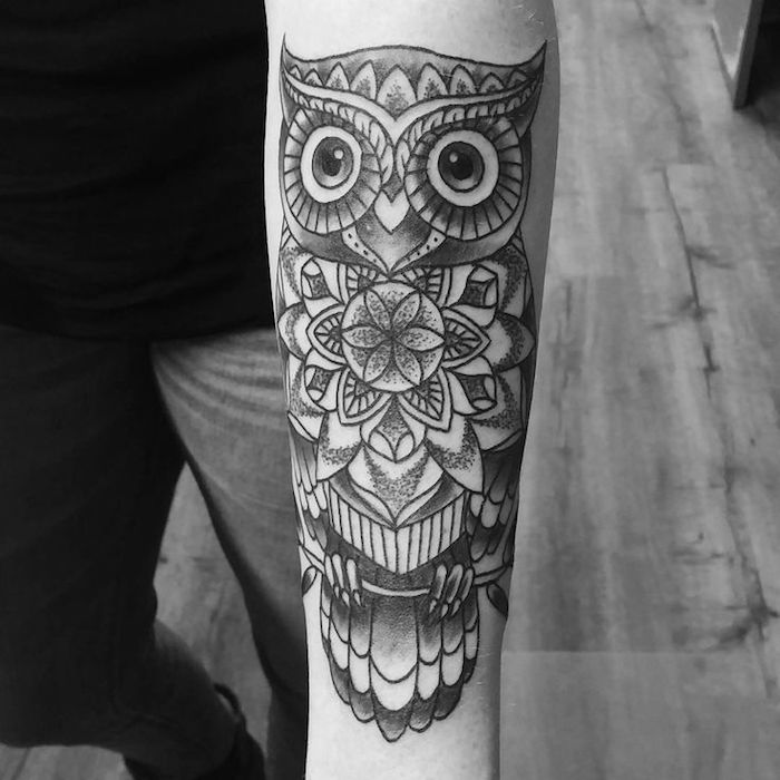mandala owl, forearm tattoo ideas, black and white photo, wooden floor