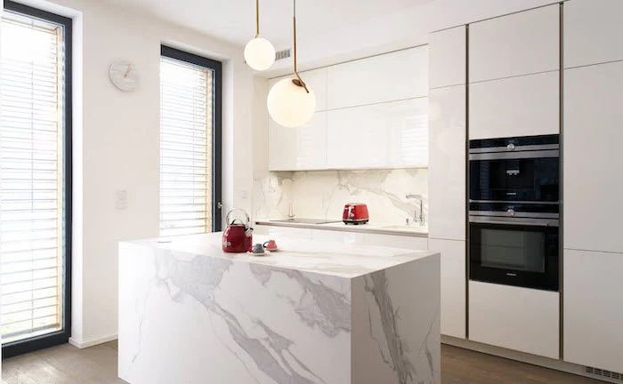 marble kitchen island, kitchen island decor, marble backsplash, white cabinets, wooden floor