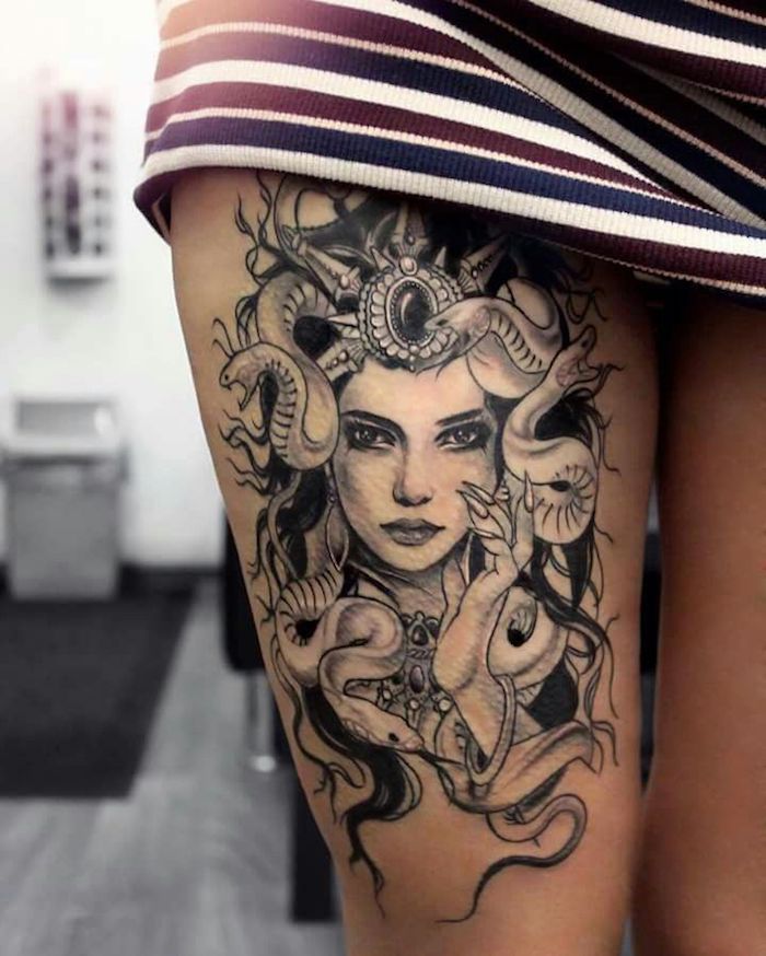 medusa head, thigh tattoo, girl chest tattoos, blue red and white, striped skirt