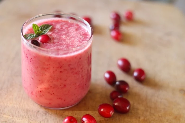 scattered berries, small glass, smoothie recipes with frozen fruit, mint on top