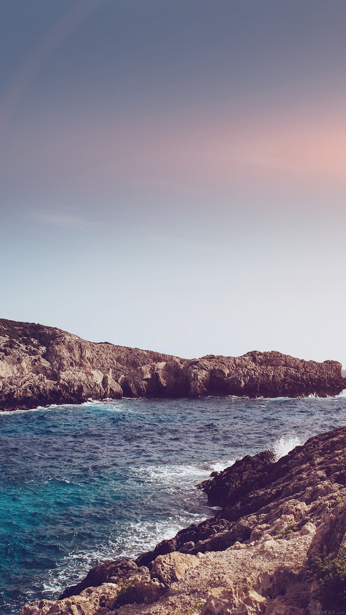 rocks by an ocean, blue and pink sky, black background tumblr