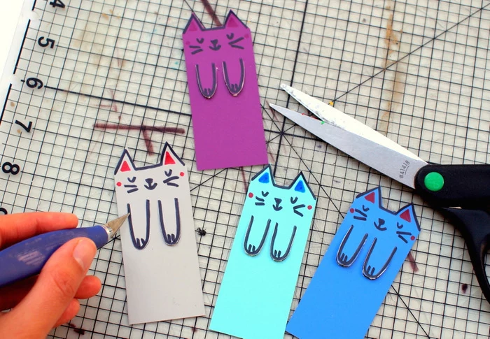 pre k learning games, colourful paper, cat faces and paws drawn on it, large ruler