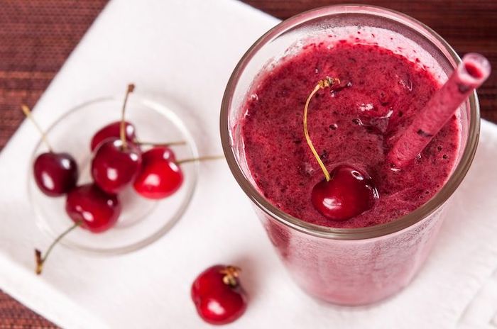 cherries on a white paper napkin, how to make healthy smoothies, tall glass, cherry on top