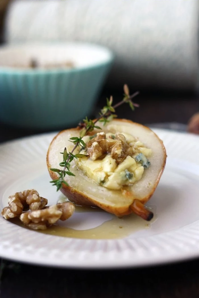 baked pear, filled with nuts and melted cheese, easy vegetarian appetizers, in a white plate
