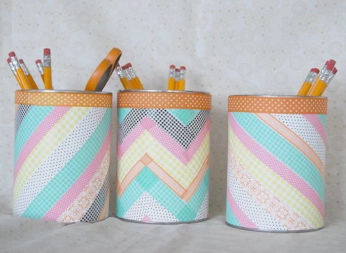 colourful washi tape, taped over tin cans, used as pencil holders, preschool learning
