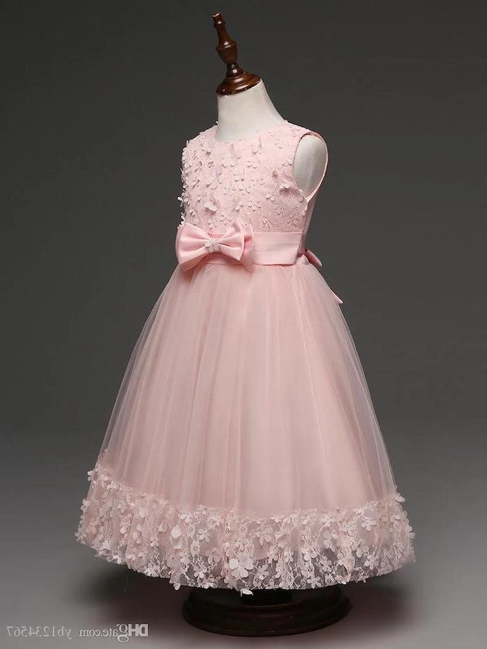 pink lace and tulle dress, with a pink bow, dressed on a mannequin, cute dresses for girls, grey background