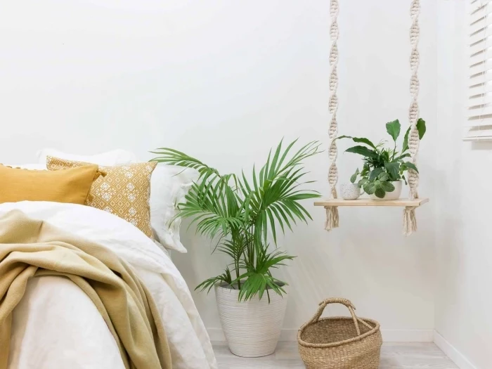 plant hanger, white wall, how to make macrame, potted plants, wooden basket, yellow throw pillows