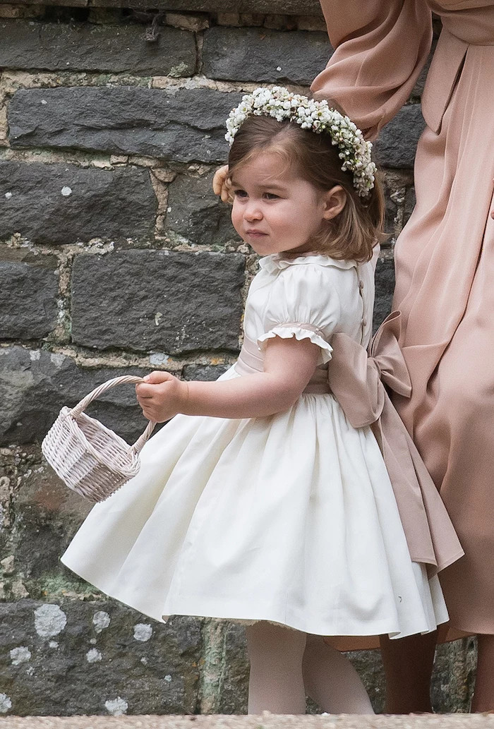 princess charlotte carrying a basket, dressed in a white dress, with ivory bow, flower girl dresses