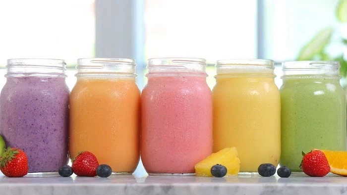 fruit slices, healthy smoothie recipes, different ingredients, in large jars