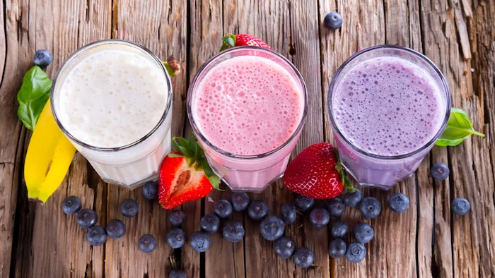 tall glasses, on wooden table, healthy smoothie recipes, berries and bananas