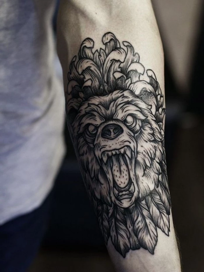roaring lion head, forearm tattoo, tattoos for men, grey shirt, blurred background