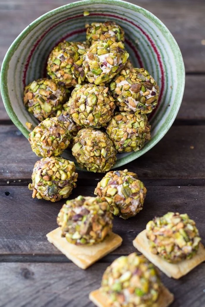 cheese pistachio bites, inside a green and red bowl, vegetarian appetizers, bites on crackers