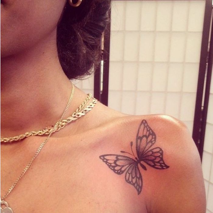 small butterfly, shoulder tattoo, gold necklaces, feminist tattoos, brown hair