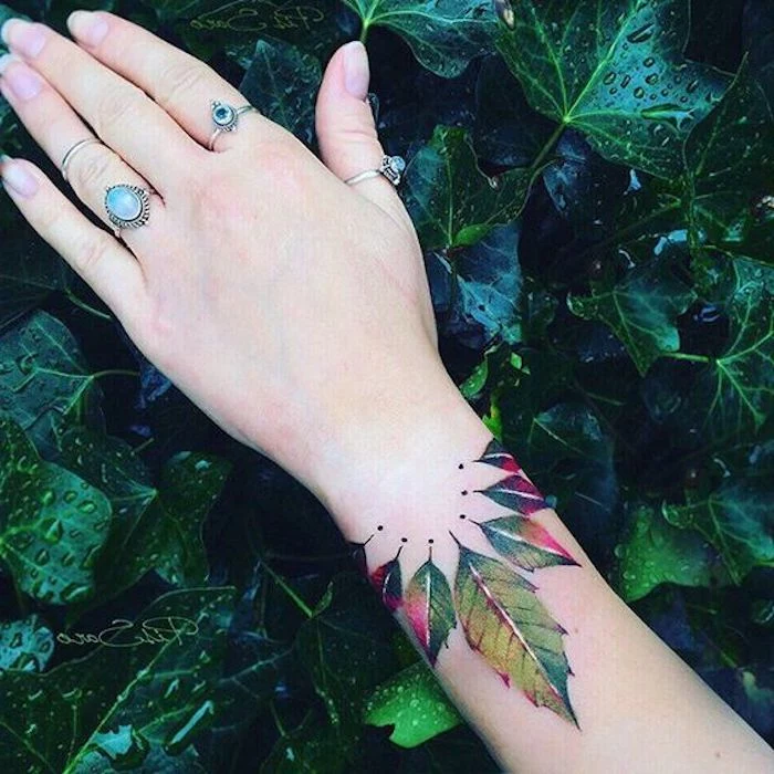 feminist tattoos, green leaves, wrist tattoo, vintage rings