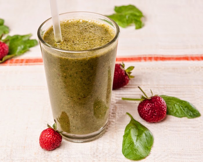 dark green smoothie, in a tall glass, strawberry banana yogurt smoothie, basil leaves