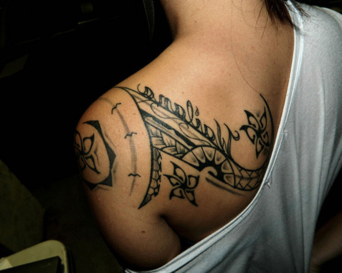 white top, feminist tattoos, symmetrical shoulder tattoo, black background