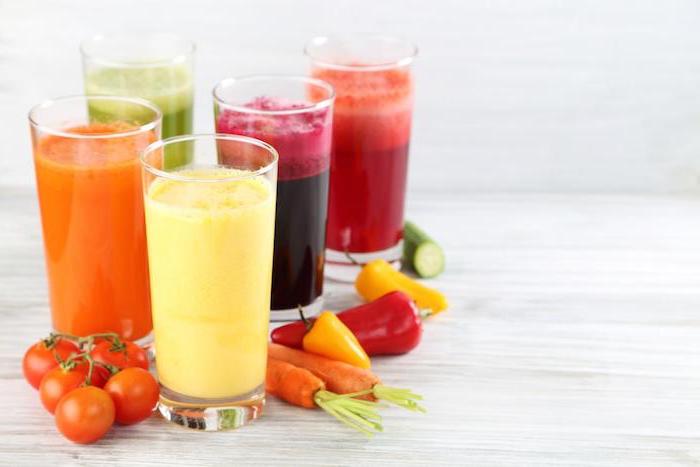 different vegetable smoothies, in tall glasses, peanut butter and banana smoothie, cherry tomatoes, peppers and carrots