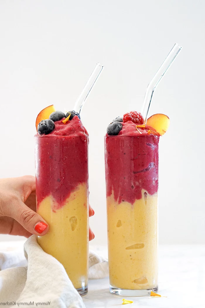 layered smoothie, fruits on top, peanut butter banana smoothie, in tall glasses