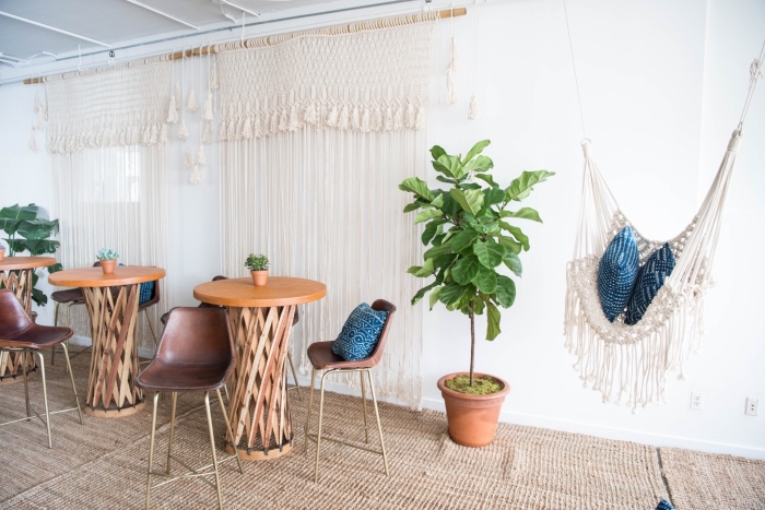 tall wooden tables, metal bar stools, white walls, macrame tapestry, macrame curtains, macrame hammock