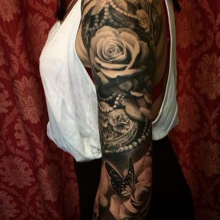 roses and pearls, arm sleeve tattoo, white top, feminist tattoos, red curtain
