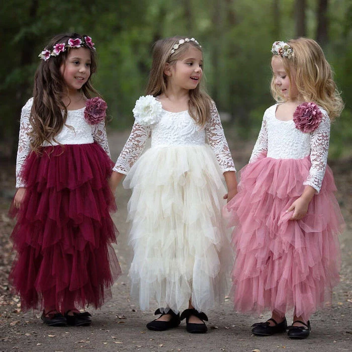 three girls, with white lace tops, red burgundy, pink and ivory tulle skirts, little girl dresses, black shoes