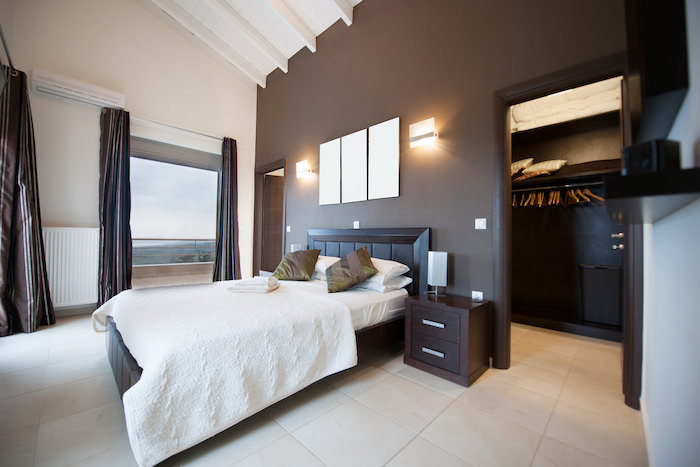 brown accent wall, tiled floor, pinterest bedroom, wooden bed frame, walk in closet