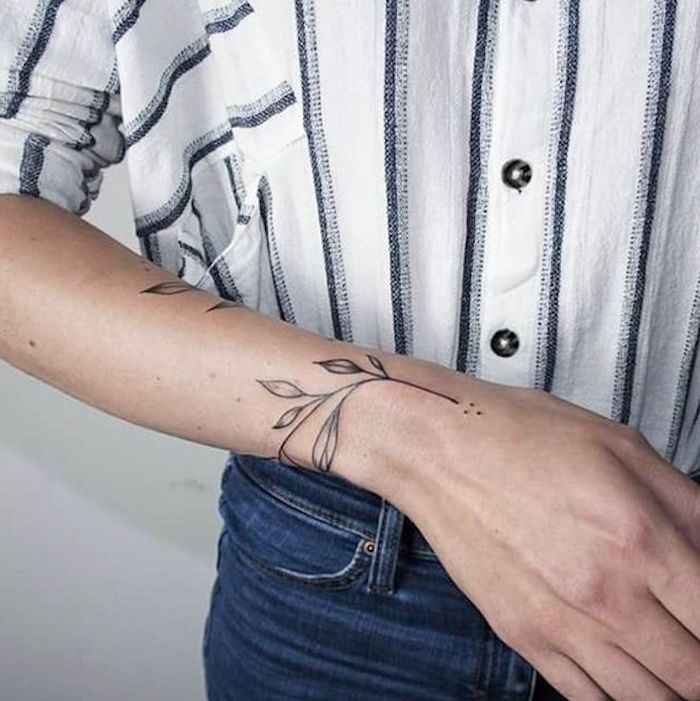 small arm tattoos, tree branch, wrist tattoo, grey and white, striped shirt