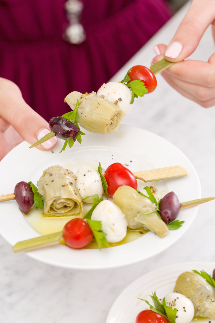 veggie pinwheels, olives and onion, mozzarella and cherry tomatoes, on a wooden skewer