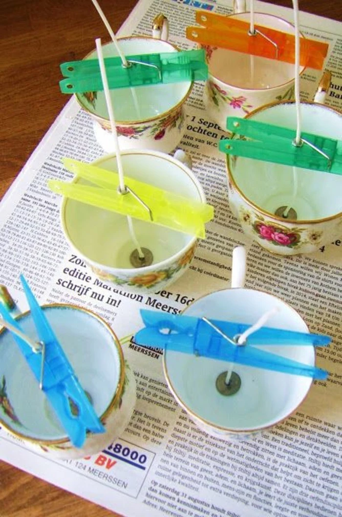 make your own candles, vintage tea cups, candle wicks inside, held with clothespins