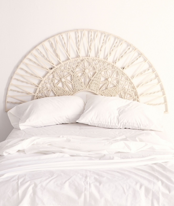 macrame bed frame, white bed linen, macrame tapestry, white wall