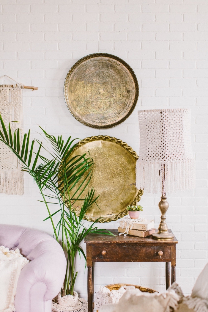 white brick wall, macrame tapestry, light purple sofa, potted palm tree, vintage wall decoration