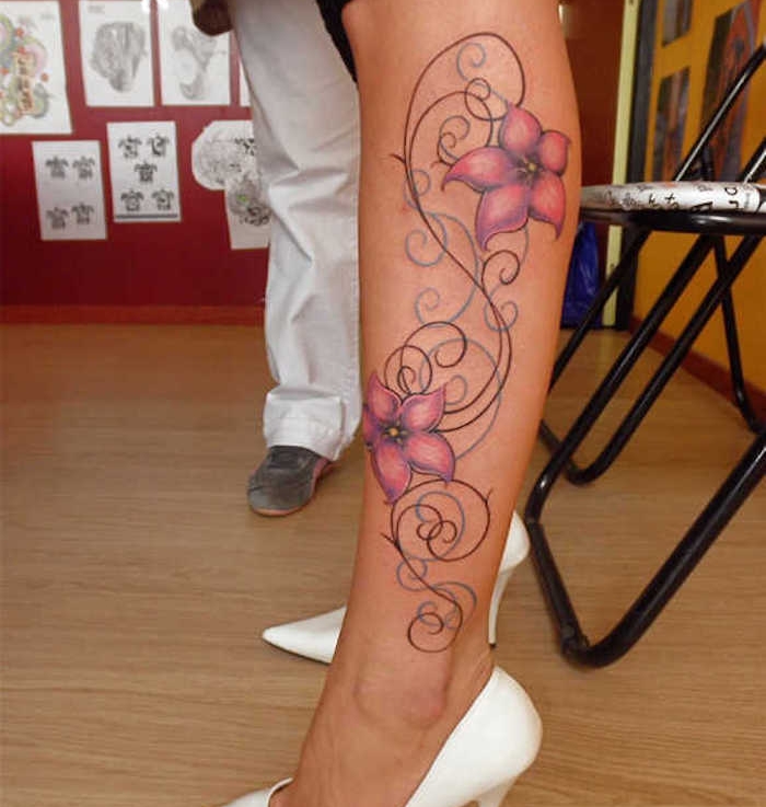pink flowers, leg tattoo, white heels, wooden floor, black metal chairs, female tattoos gallery